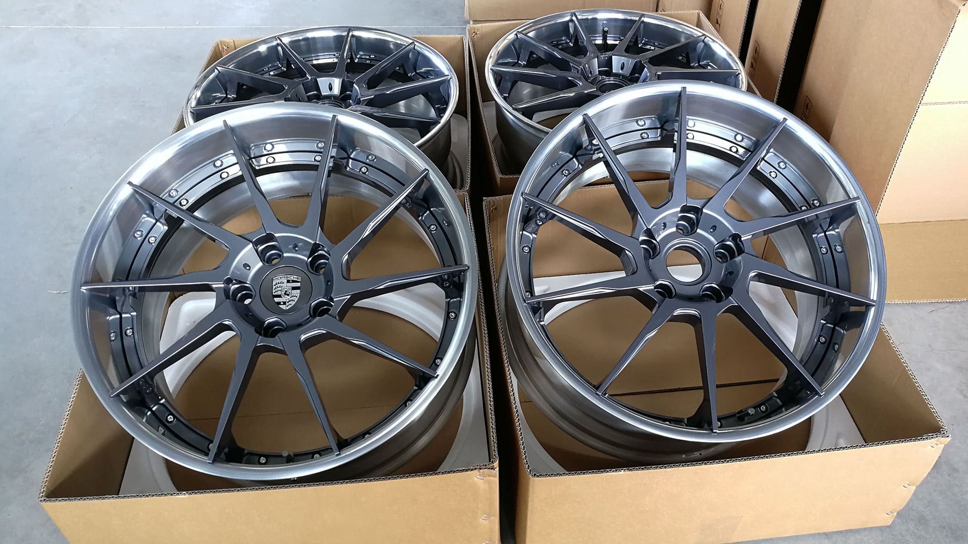 21 inch Custom Forged Wheels for Porsche sitting on warehouse floor