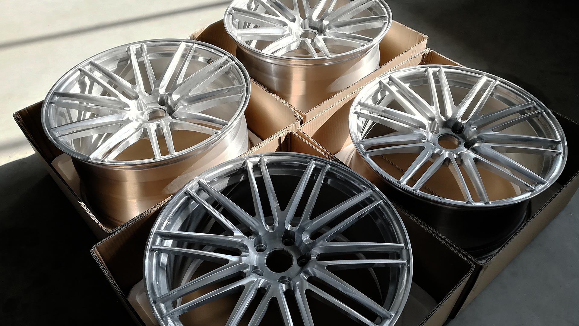 21 inch Custom Forged Wheels in polished finish on warehouse floor